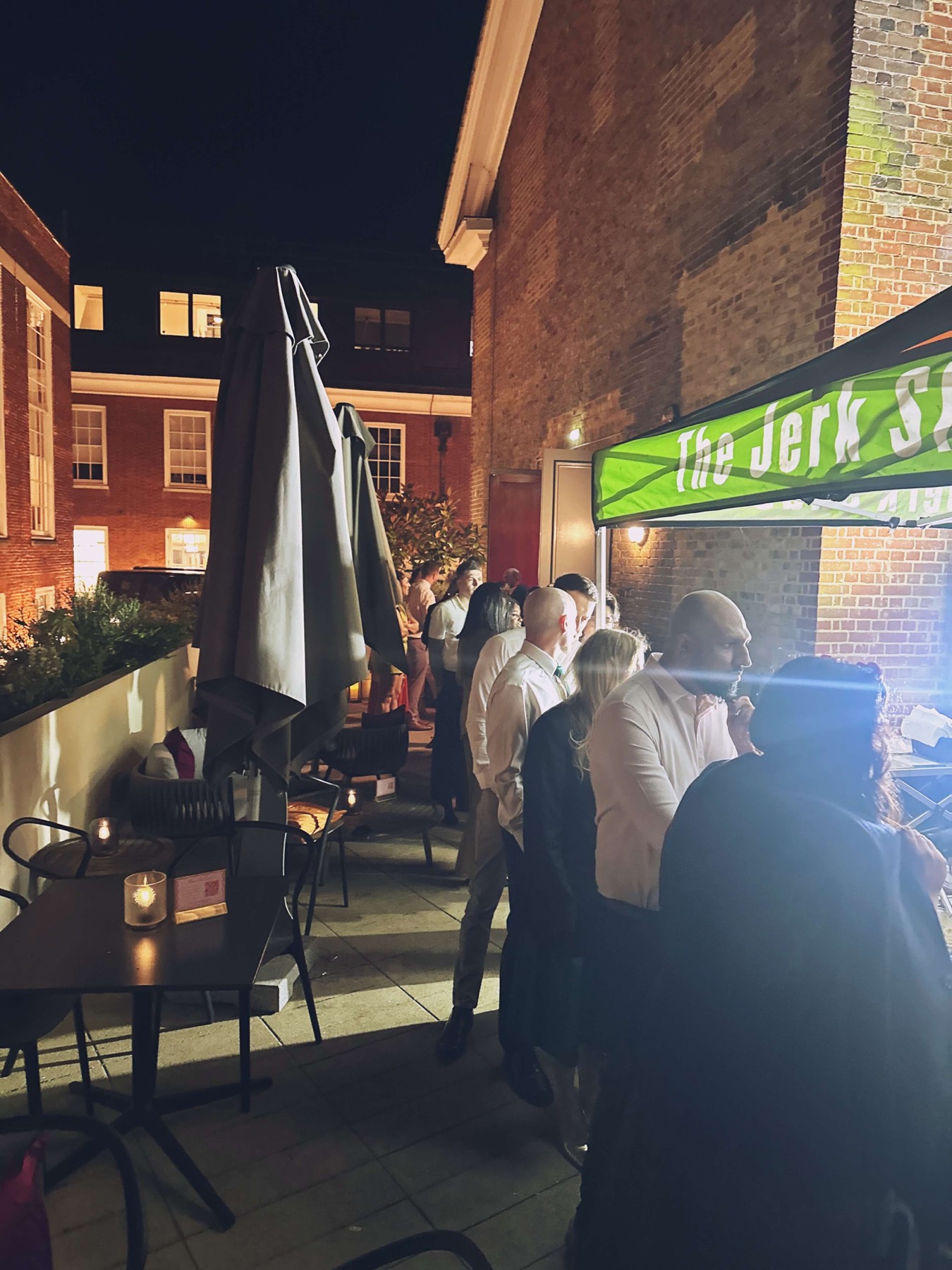 The Jerk Shac catering canopy serving guests at an evening event